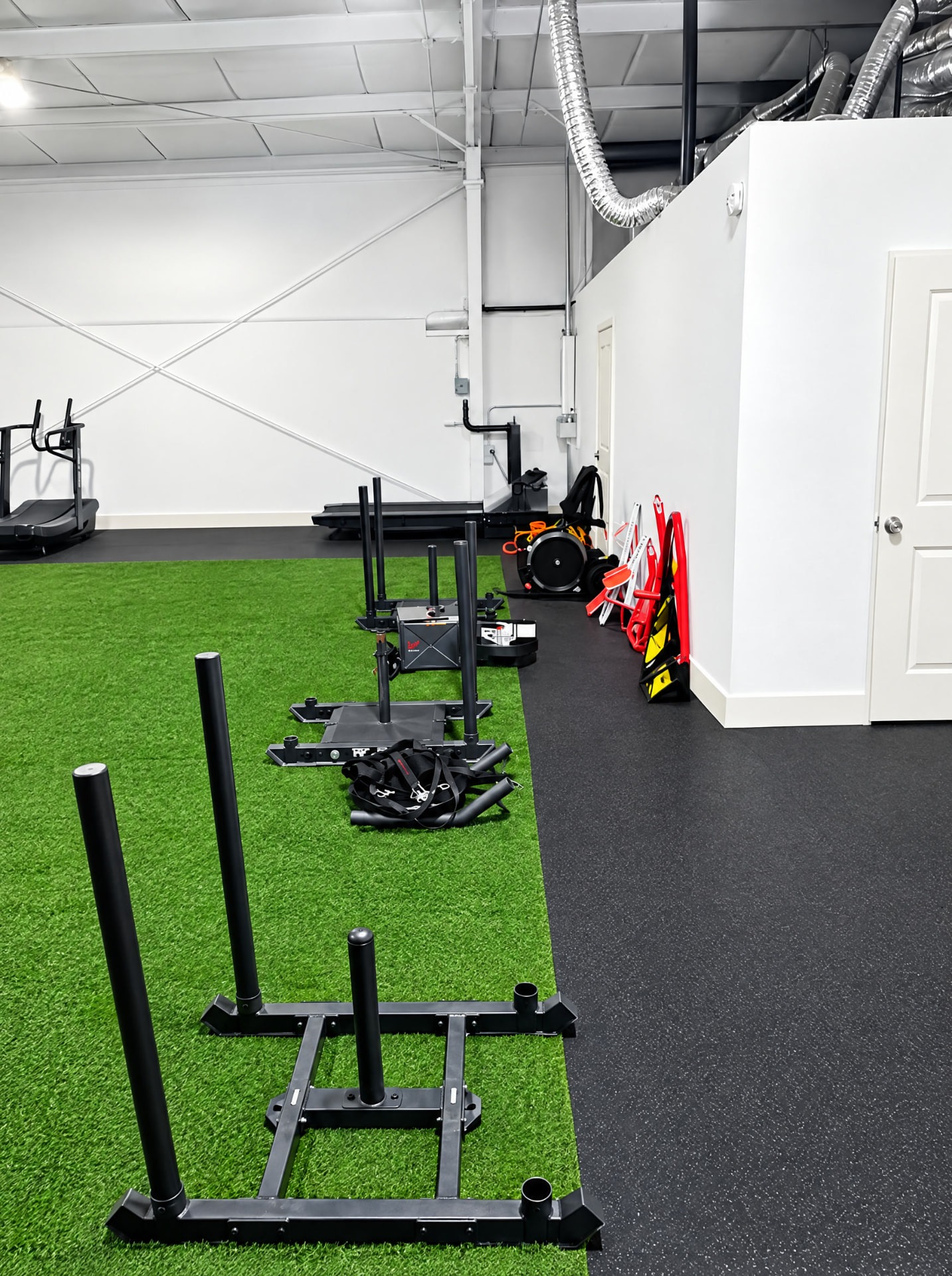 Professional push sleds lined up beside the turf at THE R